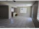 Spacious living room featuring tile flooring, a ceiling fan, and natural light from the sliding glass door at 43455 W Chisholm Dr, Maricopa, AZ 85138