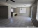 Open living room with tile floors and large windows allowing for natural light at 43455 W Chisholm Dr, Maricopa, AZ 85138