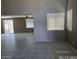 Open living space featuring tile floors, ceiling fan, and sliding door access at 43455 W Chisholm Dr, Maricopa, AZ 85138
