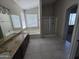 En-suite bathroom featuring double sinks, separate shower and soaking tub, and lots of natural light at 43455 W Chisholm Dr, Maricopa, AZ 85138