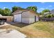 Backyard featuring a detached garage, grass, and partial privacy fence at 439 N Cherry --, Mesa, AZ 85201
