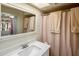 Well-lit bathroom featuring a white vanity, large mirror and a shower with a neutral curtain at 439 N Cherry --, Mesa, AZ 85201