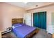 Cozy bedroom featuring rustic wooden bedframe, teal closet curtains and soft pink walls at 439 N Cherry --, Mesa, AZ 85201