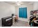 Bright bedroom featuring desk, closet, and light wood floors at 439 N Cherry --, Mesa, AZ 85201