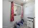 Bedroom with a large window with bright floral curtains, light gray walls and a ceiling fan at 439 N Cherry --, Mesa, AZ 85201