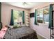 Bedroom featuring large windows, decorative shelves and cute plush toys on the bed at 439 N Cherry --, Mesa, AZ 85201
