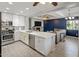 Contemporary kitchen featuring stainless steel appliances, a large island, and an open view to the living room at 439 N Cherry --, Mesa, AZ 85201