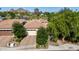 A beautiful bird's eye view of the home showcasing the mature trees, desert landscaping, and a tile roof at 4519 N 29Th Way, Phoenix, AZ 85016