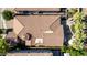 An aerial view showcases the home's tile roof, rear patio, outdoor seating, and lush surrounding trees at 4519 N 29Th Way, Phoenix, AZ 85016