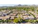 An aerial view displays the neighborhood, mature landscaping, and tile roofs with the mountains in the distance at 4519 N 29Th Way, Phoenix, AZ 85016