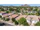 An aerial view displays the neighborhood showcasing mountain views, mature landscaping, and desert terrain at 4519 N 29Th Way, Phoenix, AZ 85016