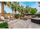 Lush backyard oasis with palm trees, a built-in BBQ, fire pit, and plenty of seating for relaxation and entertainment at 4519 N 29Th Way, Phoenix, AZ 85016
