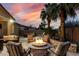 Cozy backyard with an inviting fire pit, comfortable seating, and warm lighting for evening gatherings at 4519 N 29Th Way, Phoenix, AZ 85016