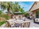 Inviting backyard featuring a built-in grill, dining space, and cozy fire pit surrounded by lush landscaping at 4519 N 29Th Way, Phoenix, AZ 85016