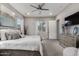 Bright bedroom with plush carpeting, a ceiling fan, neutral paint, ensuite bathroom, and lots of windows at 4519 N 29Th Way, Phoenix, AZ 85016