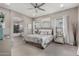 This spacious bedroom offers plush carpeting, a ceiling fan, and an ensuite bathroom with soaking tub at 4519 N 29Th Way, Phoenix, AZ 85016