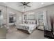 This spacious bedroom offers plush carpeting, a ceiling fan, and an ensuite bathroom with soaking tub at 4519 N 29Th Way, Phoenix, AZ 85016