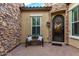 Charming stone-accented entryway with decorative iron door, bench, and window with shutters at 4519 N 29Th Way, Phoenix, AZ 85016