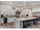 Modern kitchen with white cabinets, a large island with seating, and stainless steel appliances at 4519 N 29Th Way, Phoenix, AZ 85016