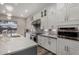 Modern kitchen with white cabinets, stainless steel appliances, mosaic backsplash, and a spacious island at 4519 N 29Th Way, Phoenix, AZ 85016