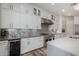 Modern kitchen with white cabinets, stainless steel appliances, mosaic backsplash, and a spacious island at 4519 N 29Th Way, Phoenix, AZ 85016
