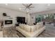 Open living room with fireplace, ceiling fan and sliding glass doors to the outdoor patio at 4519 N 29Th Way, Phoenix, AZ 85016