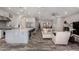 Open-concept living space with kitchen island, living room, and dining area with wood-look flooring at 4519 N 29Th Way, Phoenix, AZ 85016