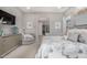 Primary bedroom featuring neutral tones, soft carpet, ensuite bathroom with soaking tub, and bright windows at 4519 N 29Th Way, Phoenix, AZ 85016