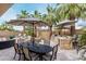 An expansive backyard with a dining set and built-in grill, perfect for entertaining under mature palm trees at 4519 N 29Th Way, Phoenix, AZ 85016