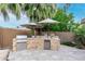This outdoor kitchen features stone accents, a built-in grill, and stainless steel appliances for the perfect entertainment space at 4519 N 29Th Way, Phoenix, AZ 85016