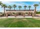 A covered outdoor structure with a fireplace and stone pillars overlooks a lush green lawn, offering shade and charm at 4519 N 29Th Way, Phoenix, AZ 85016