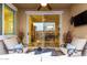 Cozy covered patio with comfortable seating and a view into the dining area through sliding glass doors at 4519 N 29Th Way, Phoenix, AZ 85016