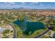 Expansive aerial view of a lakeside community with lush landscaping and mountain views at 5 E Oakwood Hills Dr, Chandler, AZ 85248