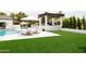 Backyard features a pool, lounge chairs, and an elegant gazebo, creating a serene and luxurious outdoor retreat at 5 E Oakwood Hills Dr, Chandler, AZ 85248