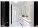 Sophisticated bathroom with a double vanity, glass shower, and stylish lighting, creating a luxurious and functional space at 5 E Oakwood Hills Dr, Chandler, AZ 85248