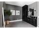 Chic bathroom featuring black cabinets, marble countertops, and contemporary fixtures, creating a sleek and modern space at 5 E Oakwood Hills Dr, Chandler, AZ 85248