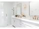 Elegant bathroom with double vanity, gold fixtures, and a glass-enclosed shower, offering a luxurious and bright space at 5 E Oakwood Hills Dr, Chandler, AZ 85248