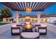 Charming cabana featuring a fire table and comfortable seating, overlooking a sparkling pool and lush backyard at 5 E Oakwood Hills Dr, Chandler, AZ 85248