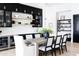 Modern dining room with black cabinets and stylish wood table set for entertaining at 5 E Oakwood Hills Dr, Chandler, AZ 85248