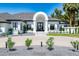 Elegant home with a circular entryway, lush landscaping, and a well-manicured lawn at 5 E Oakwood Hills Dr, Chandler, AZ 85248