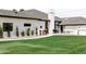 Lush green lawn complements this home's white stucco exterior with manicured landscaping and a modern design at 5 E Oakwood Hills Dr, Chandler, AZ 85248