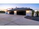 Modern home featuring a three car garage with contemporary doors and elegant outdoor lighting at 5 E Oakwood Hills Dr, Chandler, AZ 85248
