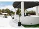 Elegant outdoor gazebo with white columns and dark wood pergola featuring stylish seating and a charming outdoor aesthetic at 5 E Oakwood Hills Dr, Chandler, AZ 85248