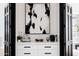 White drawers with black hardware and ornate black and white artwork at 5 E Oakwood Hills Dr, Chandler, AZ 85248