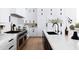 Bright kitchen featuring white cabinets, black hardware, stainless steel appliances and a marble countertop at 5 E Oakwood Hills Dr, Chandler, AZ 85248