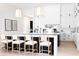 Kitchen featuring an island with bar stool seating, white cabinets, and stainless steel appliances at 5 E Oakwood Hills Dr, Chandler, AZ 85248