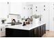 Modern kitchen with a black island, white countertops, and stainless steel appliances at 5 E Oakwood Hills Dr, Chandler, AZ 85248