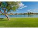 Scenic view of a calm lake surrounded by lush green grass and trees at 5 E Oakwood Hills Dr, Chandler, AZ 85248