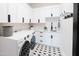 Well-organized laundry room with modern appliances, sleek cabinets, and stylish flooring, making laundry a breeze at 5 E Oakwood Hills Dr, Chandler, AZ 85248