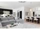 Open-concept living space featuring a large sectional sofa, modern kitchen, and stylish breakfast bar at 5 E Oakwood Hills Dr, Chandler, AZ 85248